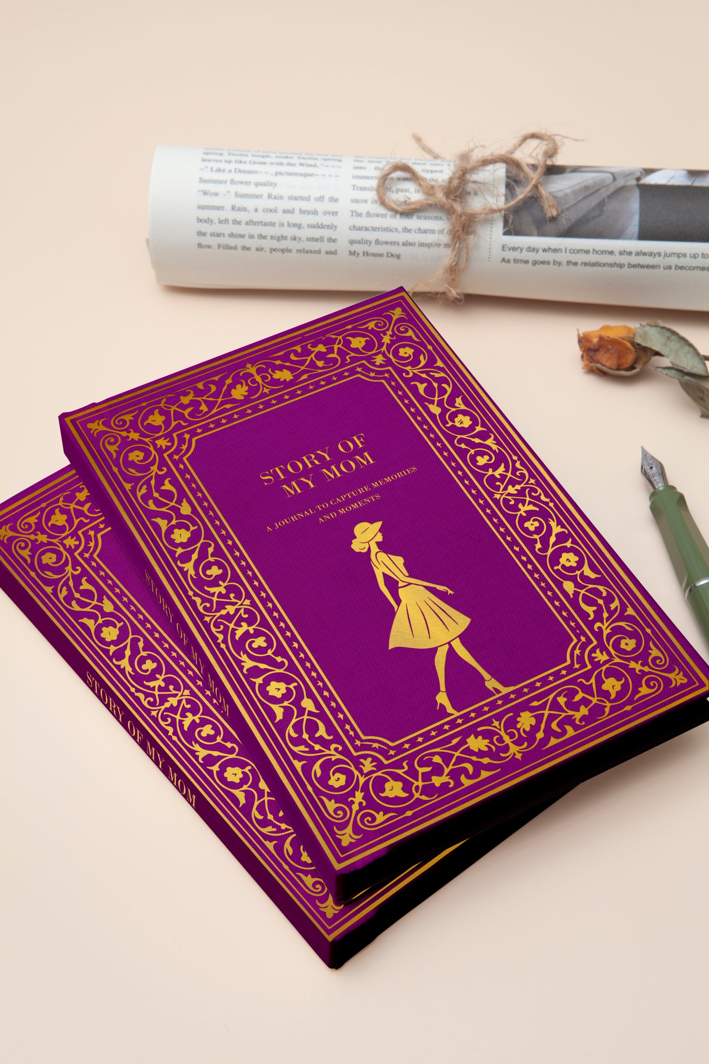 Purple book with gold design and text on a beige surface