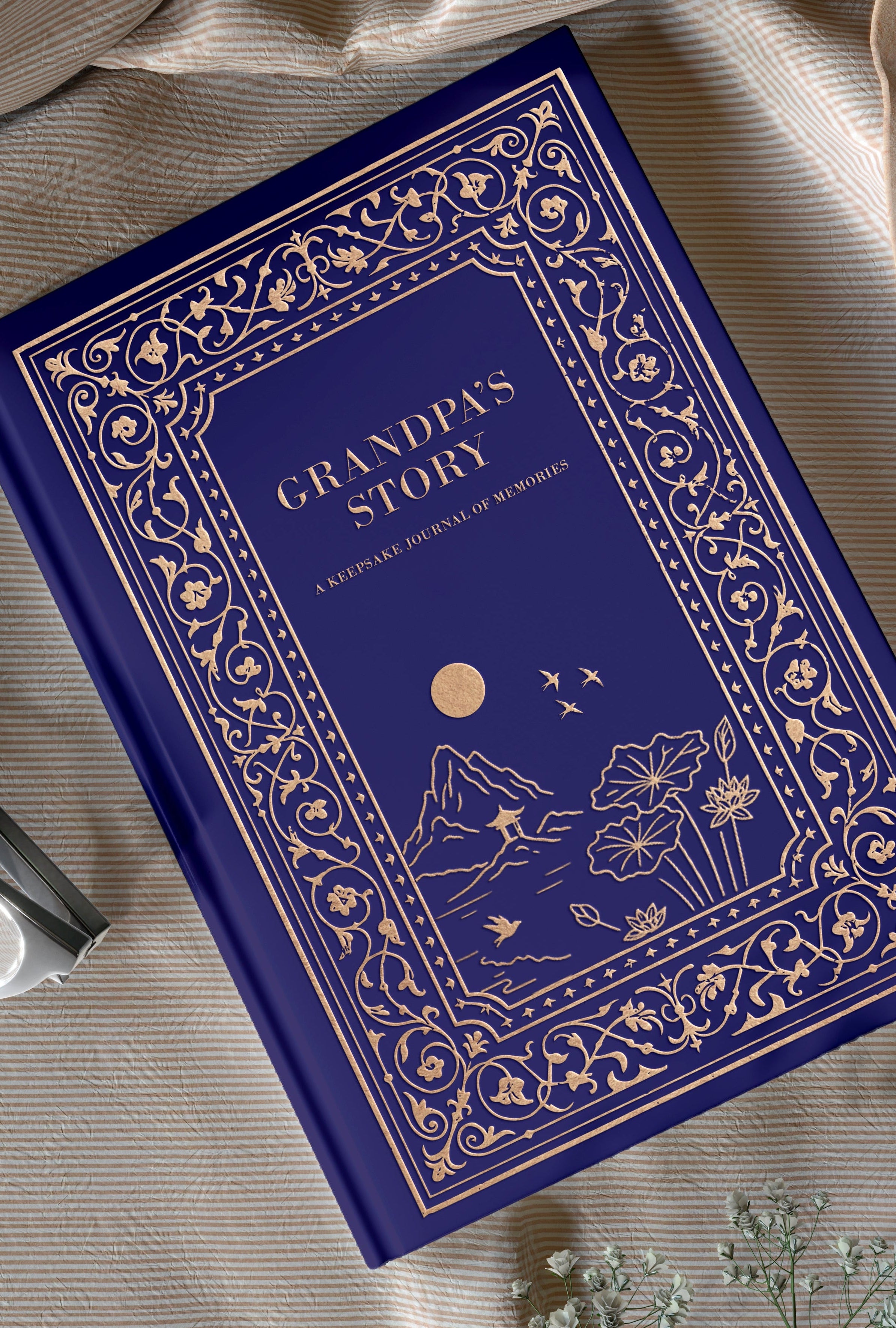 Blue book titled 'Grandpa's Story' on a beige fabric background with flowers.