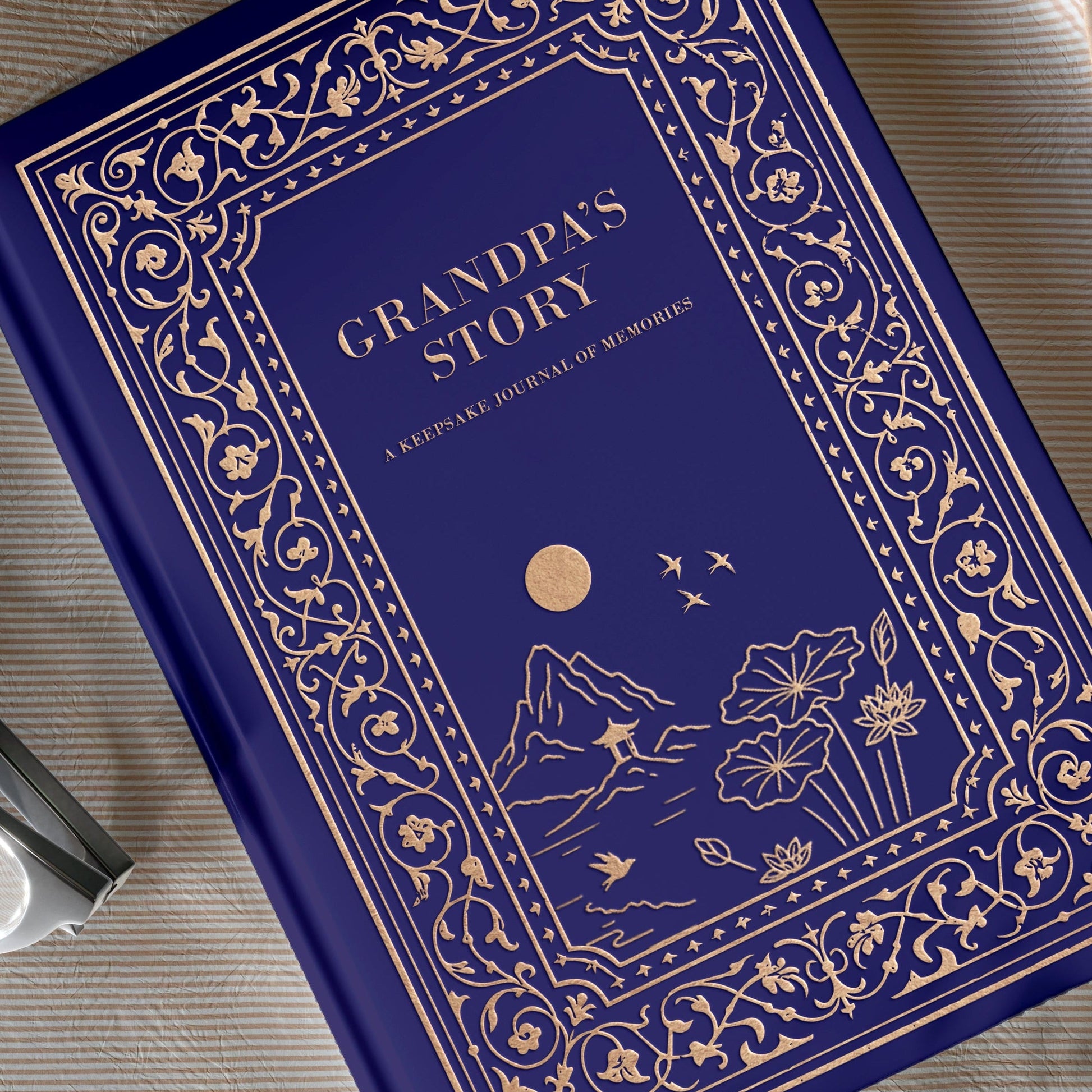 Blue book titled 'Grandpa's Story' on a beige fabric background with flowers.