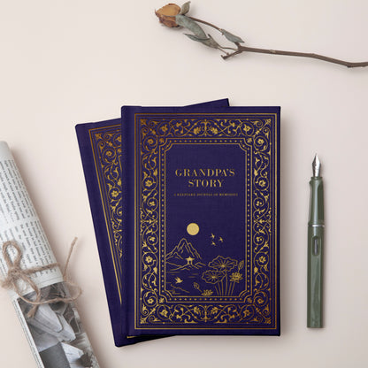 Two blue books titled 'Grandpa's Story' with decorative cover design, a rolled-up paper, and a pen on a light background.