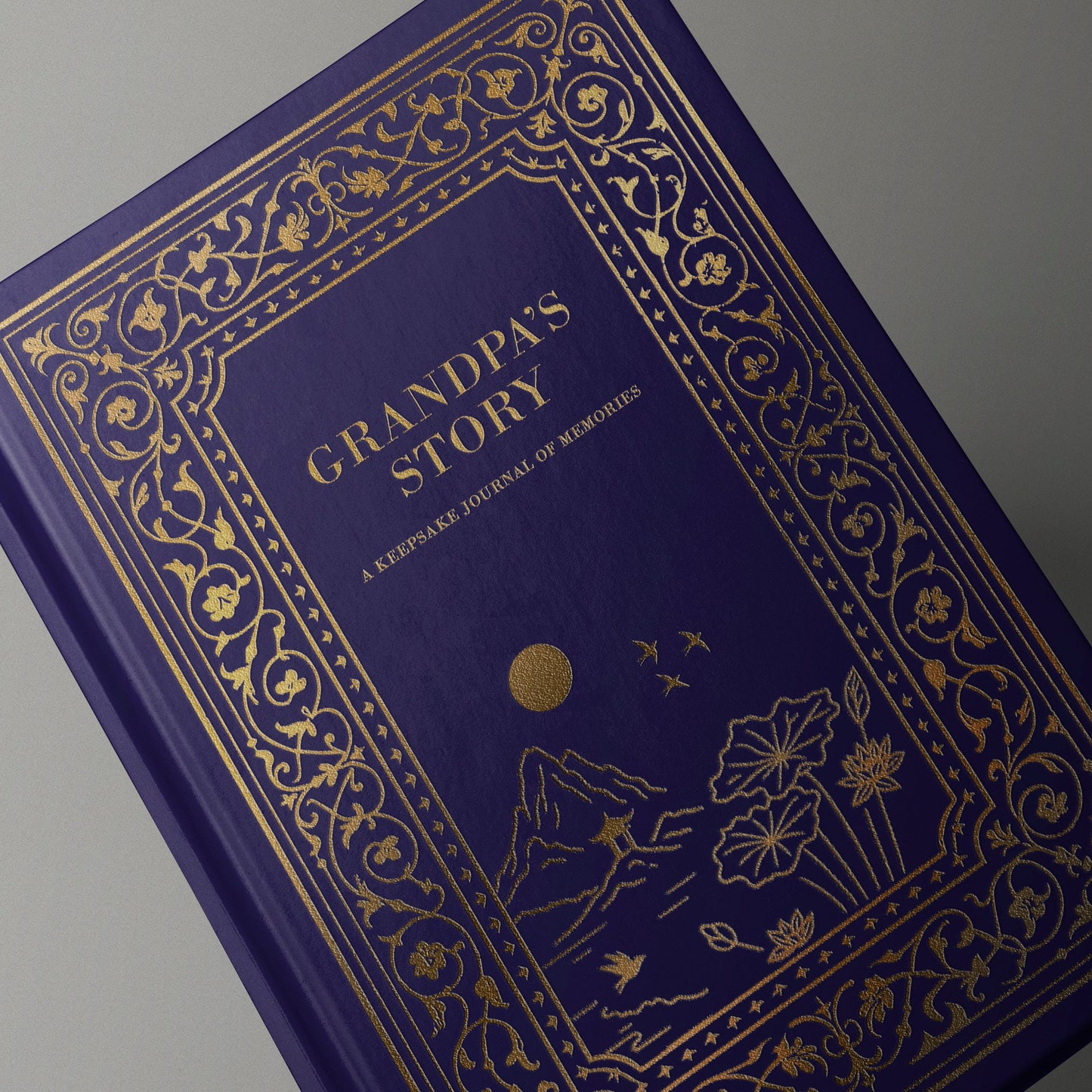 Blue book titled 'Grandpa's Story' with gold decorative elements on a gray background